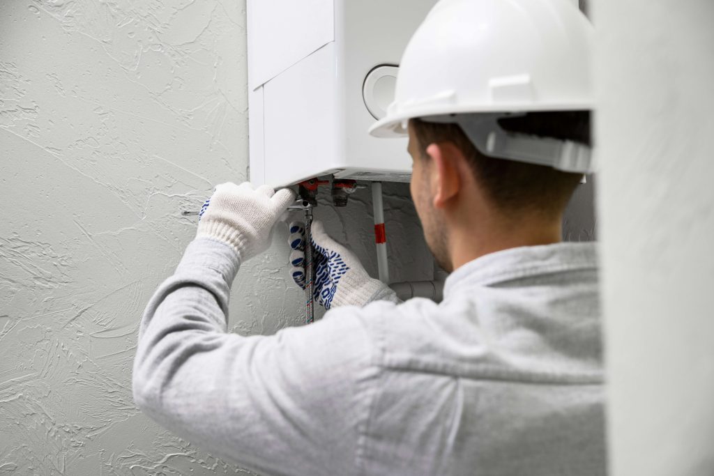 worker-repairing-water-heater-2-2-11zon