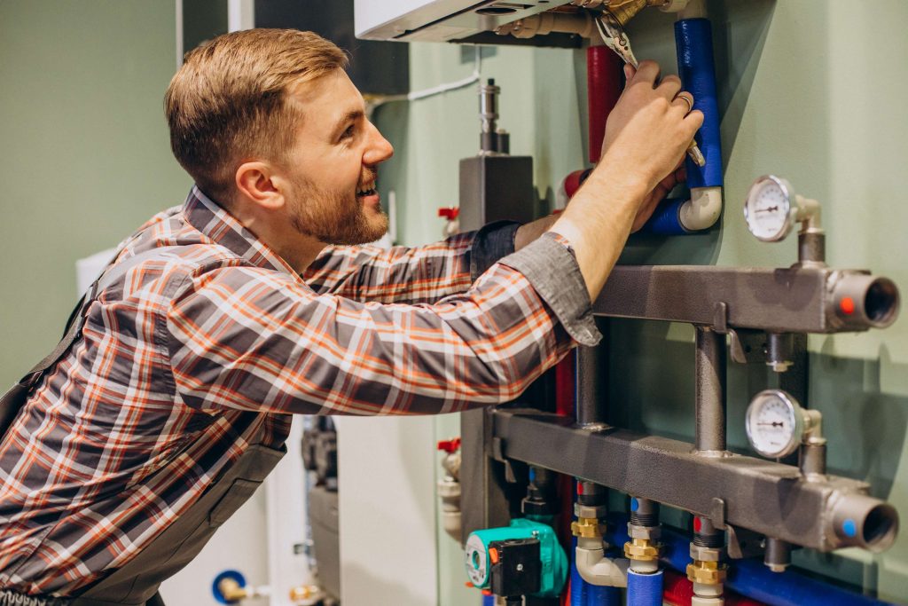 young-engineer-adjusting-autonomous-heating-4-11zon